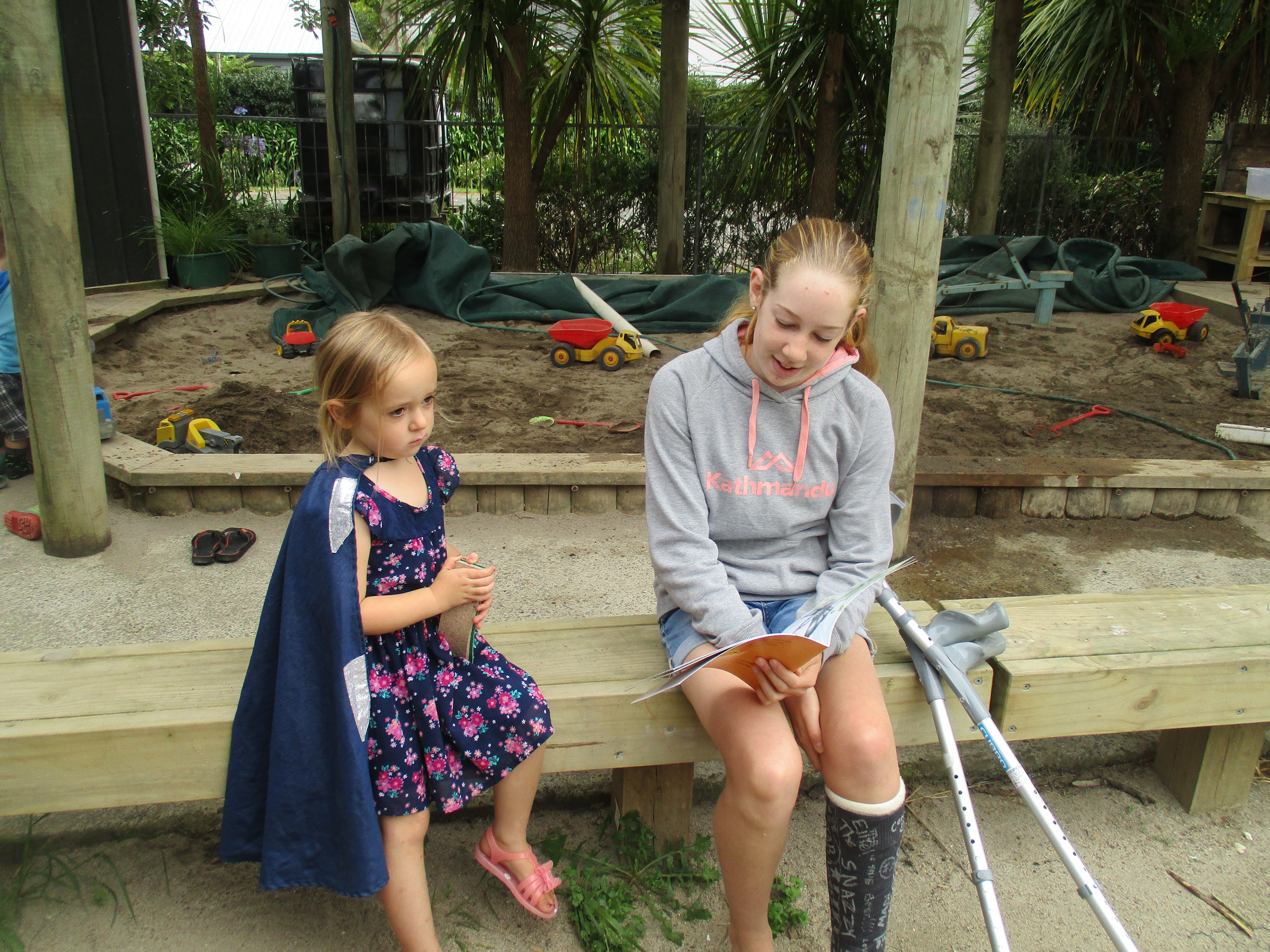 Te Pahu Preschool children being read to by Te Pahu school student
