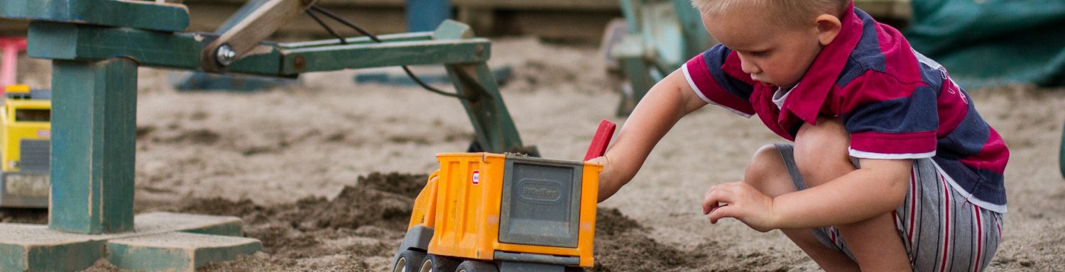 Te Pahu Preschool child playing with digger in the sandpit