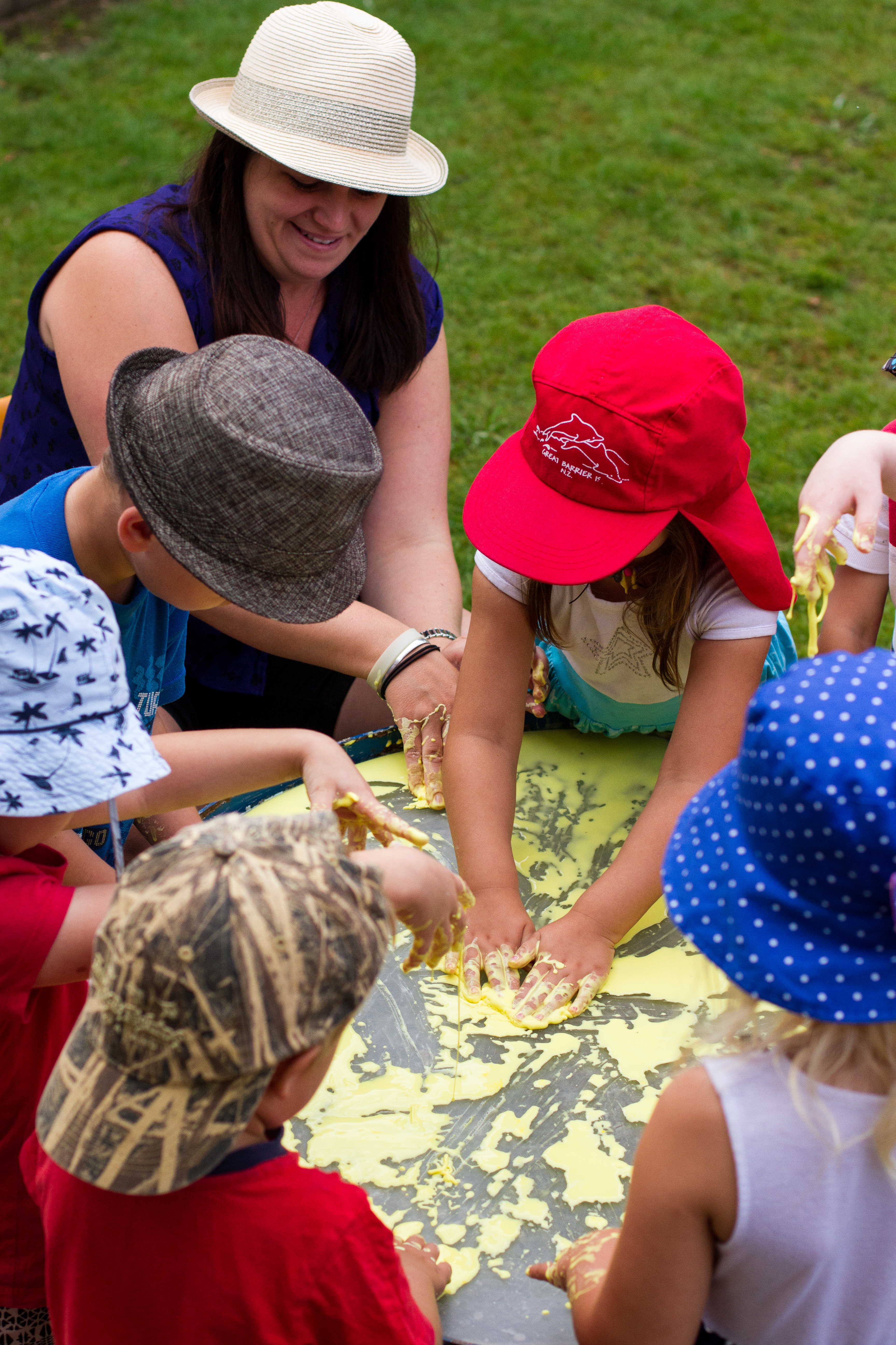 Te Pahu Preschool children with their teacher enjoying messy play