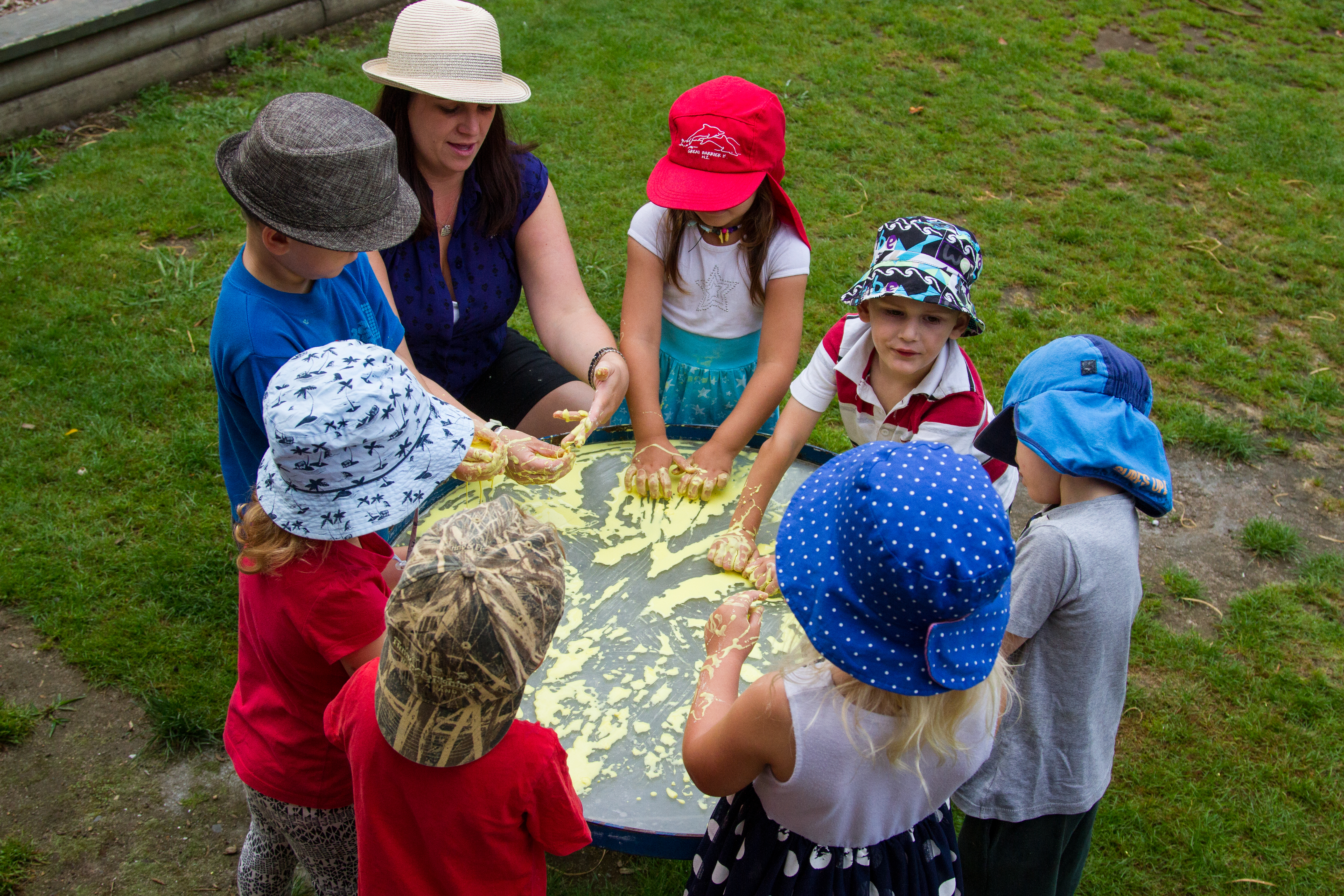 Te Pahu Preschool children enjoying messy play with their teacher